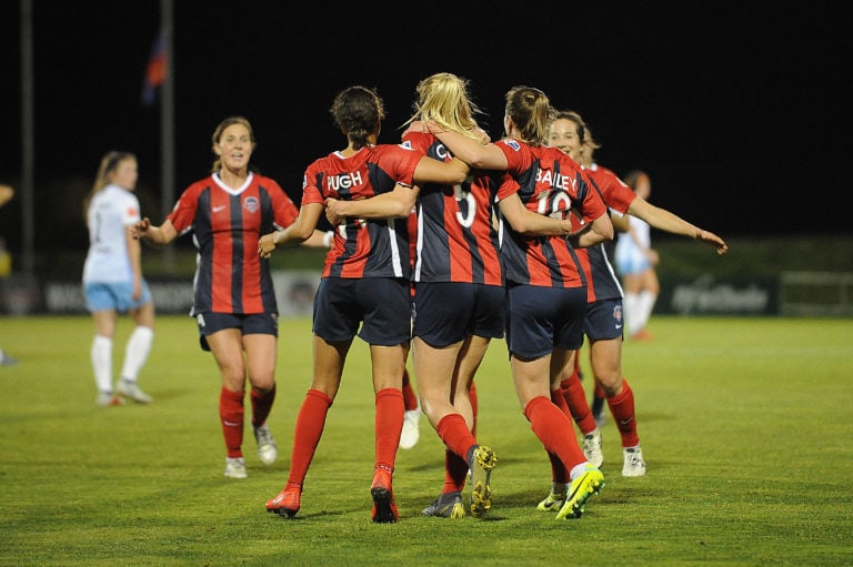 Megan Crosson, Mallory Pugh, Dorian Bailey celebrating on field