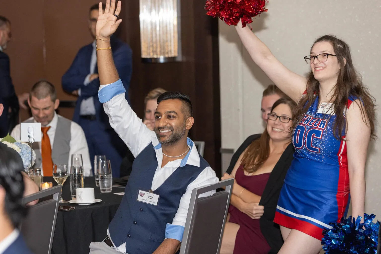 Gala attending bidding during live auction, Cheer DC helping identify bidders